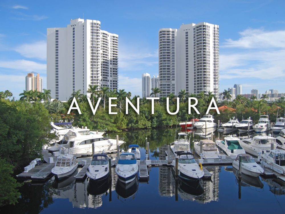 Aventura condo buildings on oceanway with various yachts in front of them