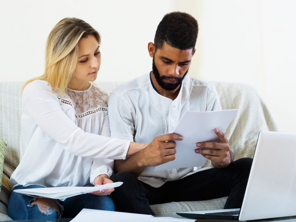 Young Couple filling papers for mortgage